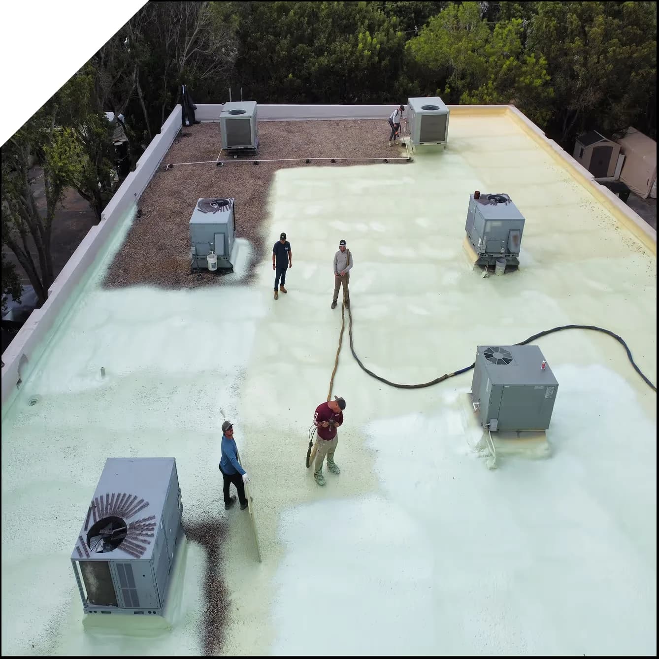 a crew performing a commercial roof coating job