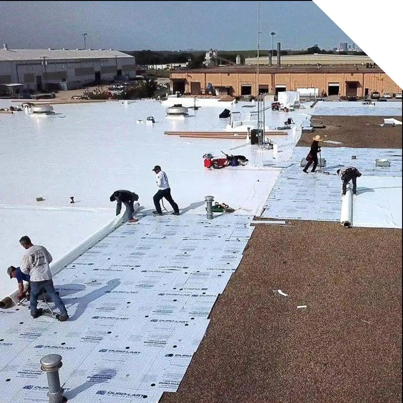 a crew performing a commercial roof recover job